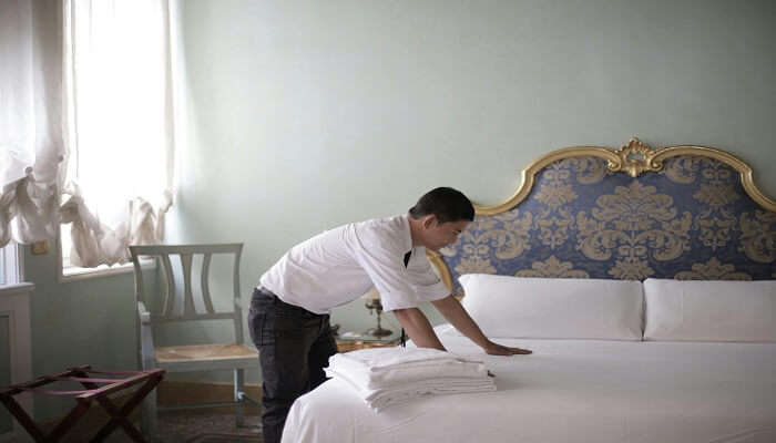  Staff working in one of the hotels in Maruthamalai room