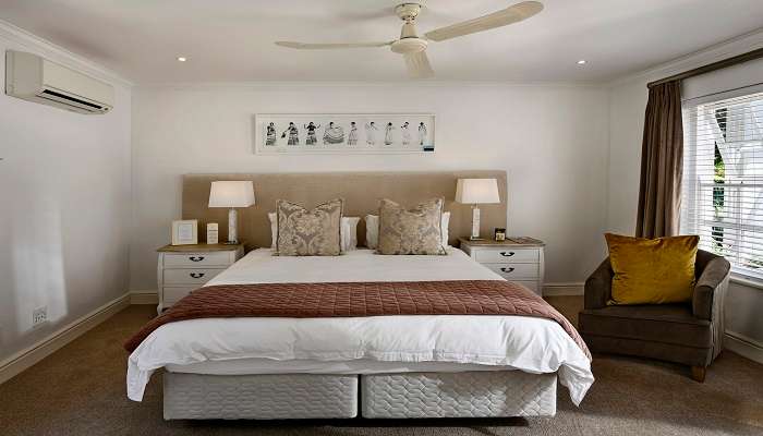 A king-size bed in a hotel room in a resorts in Pachmarhi