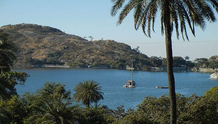 Serene waters of Nakki Lake with surrounding hills in Mount Abu