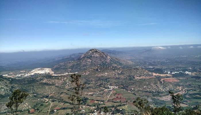 Picturesque sunrise at Nandi hills with clouds-covered valleys