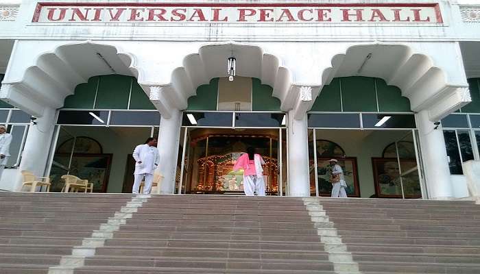 A group of people practicing outdoor meditation at Peace Park, Mount Abu.