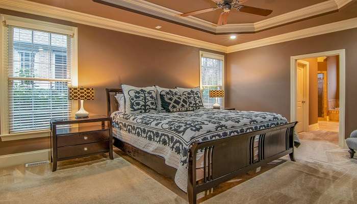 A lavish brown theme bedroom with windows