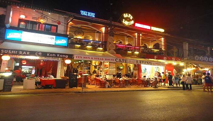 Vibrant pub street lined by shops and bars