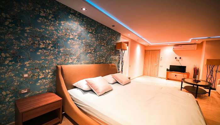 A huge bed with decorative walls shining in the lights