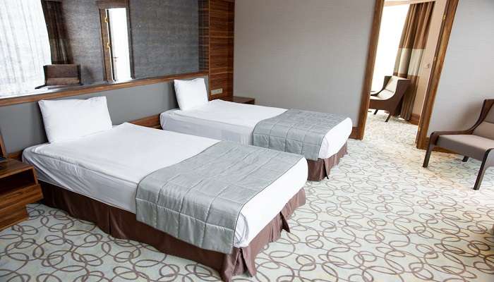 Twin beds in white linen in a hotel. 