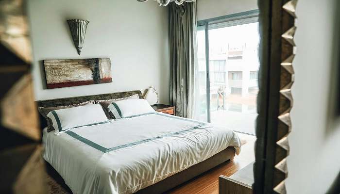 hotel room with a cosy bed, sleek design, and city view, ideal for comfort and relaxation.