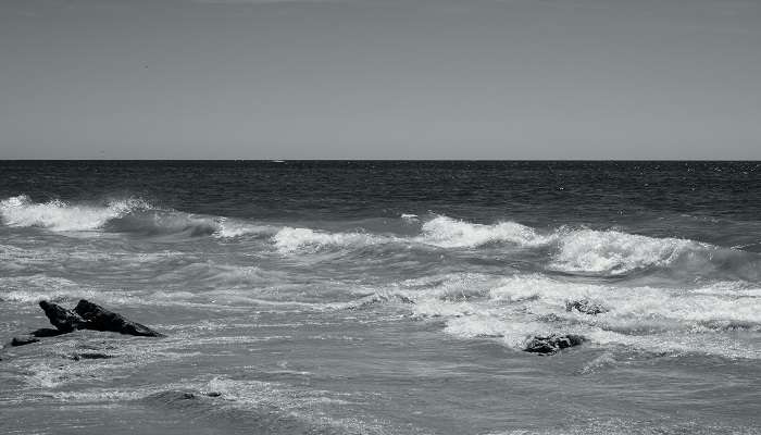 White waves bathing the rocky terrain of Black Rock Beach