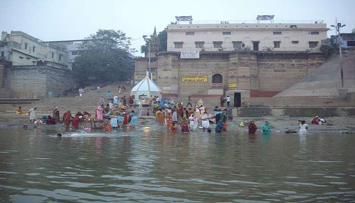  take a holy bath near shivala ghat in Varanasi 