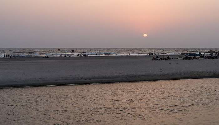 People enjoying the sunset at Mandrem Beach, Goa