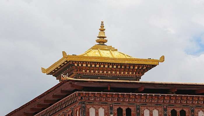 Intricate woodwork and stunning golden spire depicting rich architecture of Tashichho Dzong.