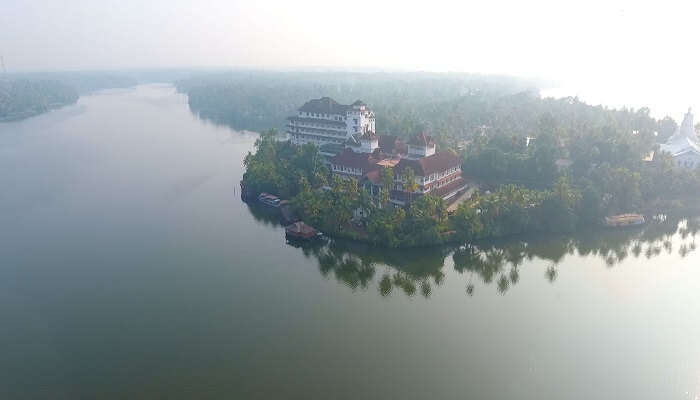 People standing on a blue colour boat at the Ashtamudi Lake