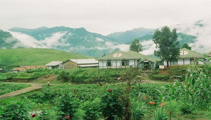 Scenic view of the town surrounded by lush green mountains