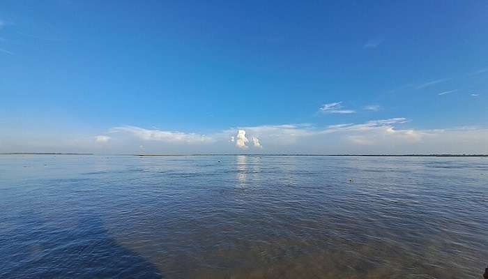 View of the Brahmaputra River with lush green surroundings.