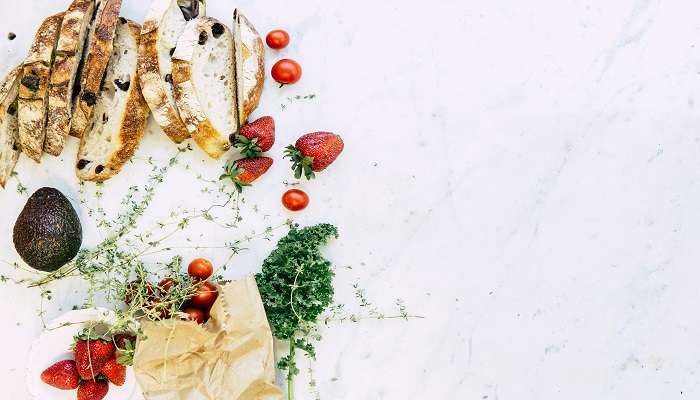 Appreciating gourmet strawberries with sliced bread at Eden Park Restaurant, among the highly regarded restaurants near Cubbon Park