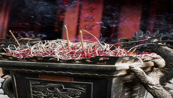  Burning incense at Enchey Monastery Sikkim.