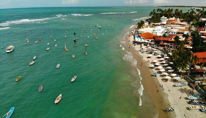 A view of a luxurious resort overlooking the beach, with amenities that spell relaxation and comfort.