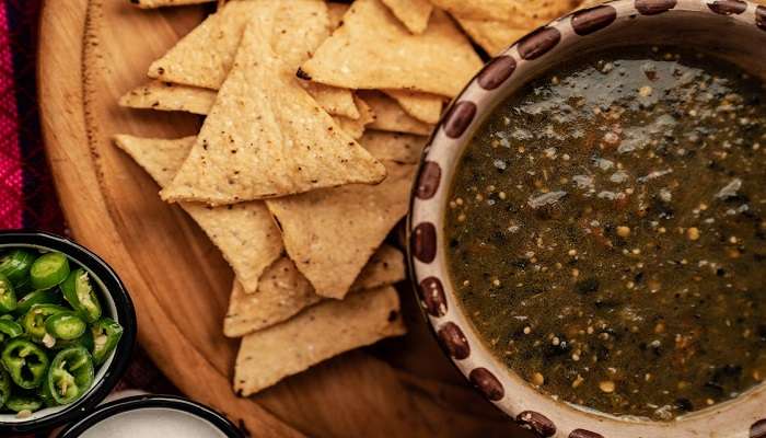 A plate full of nachos and salsa