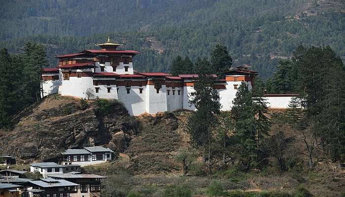 Dzong in Paro valley surrounded by verdant rolling hills