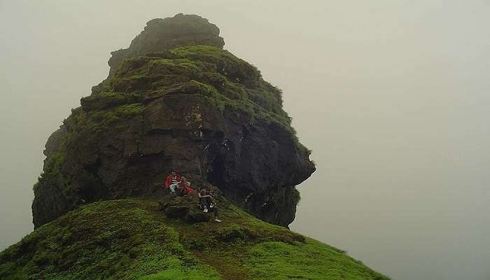 the Irshalgad Fort is located at a towering peak near Bhivpuri Waterfalls