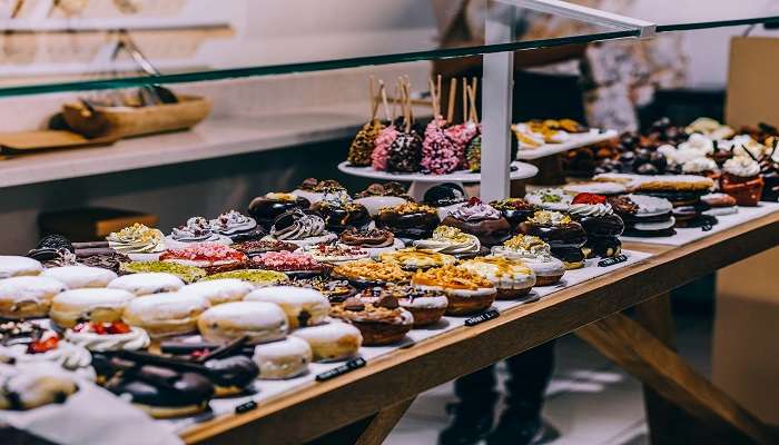 Donuts and bagels on display in a eatery