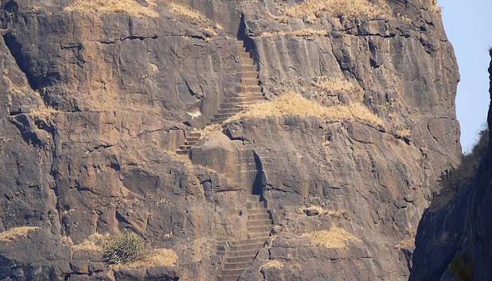 the spectacularly established rock-cut temple and stairs of Kalavantin Durg 