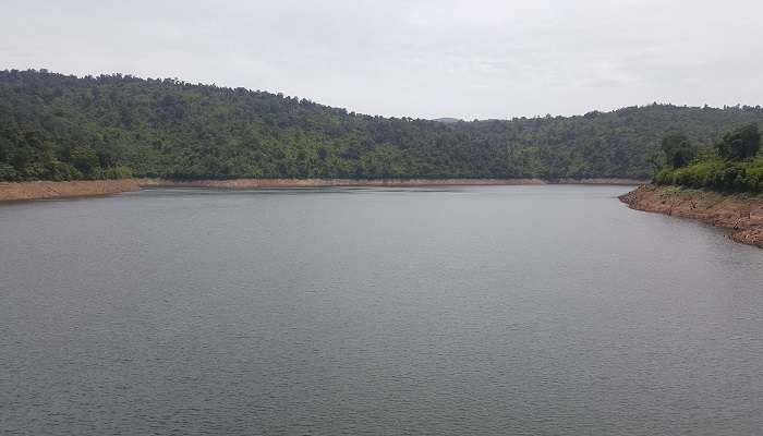 View of the Kamaki Hydropower Dam surrounded by lush rice fields and hills 