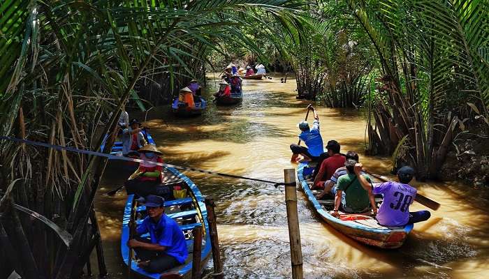 Tourists enjoying Kayaking the canals of My Tho