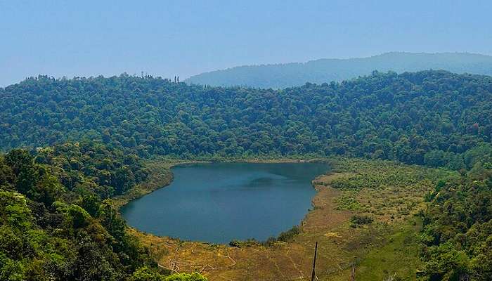 Pristine Khecheopalri lake surrounded by lush greens and beauty in Yuksom