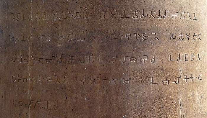 Closer look of Ashoka Pillar with inscription marking a significant Buddhist site