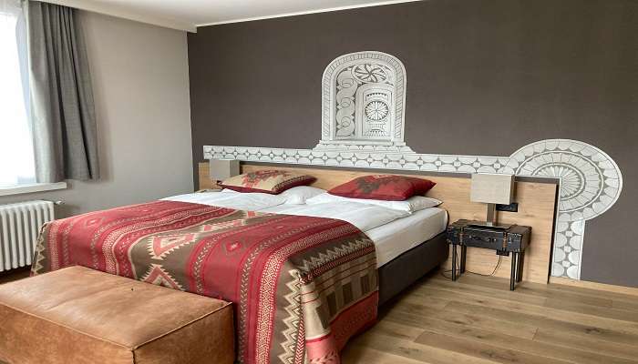 A bed with a decorated wall