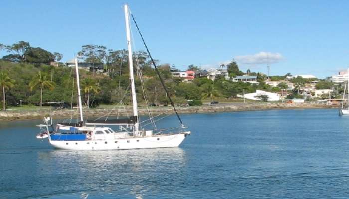 Boats near the ocean with blue sky in the background