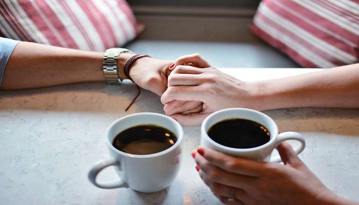 Couple enjoying coffee away from the hustle and bustle at River Rock Cafe in Mackay.