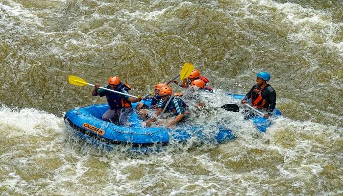 Group of friends doing river rafting in Awastone