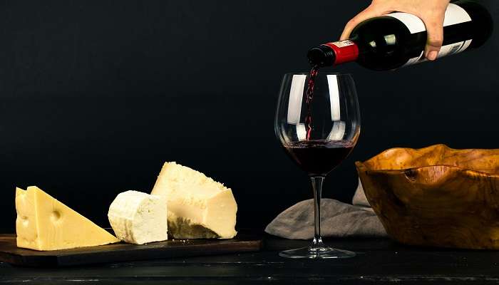 An image of wine and cheese.