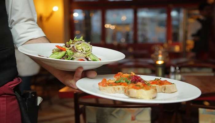 A person holding a dish of pastry and salad at the top Restaurants in Warrnambool.