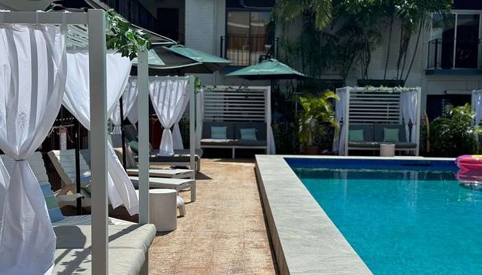 Poolside seating at The Cavenagh Hotel.