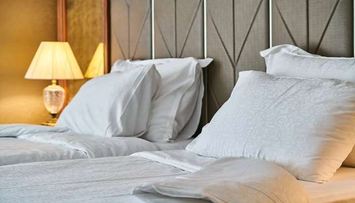 Bed with white linen in a hotel room