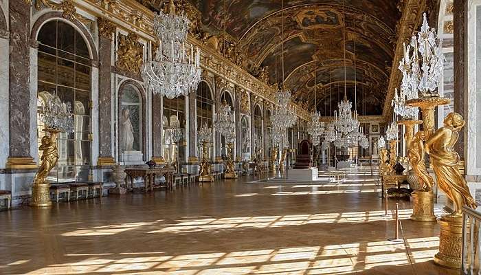 The Hall of Mirrors with its grand chandeliers and mirrored walls.