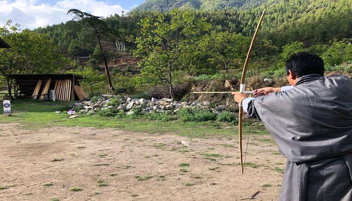 Tourist taking Part in Archery in Mongar