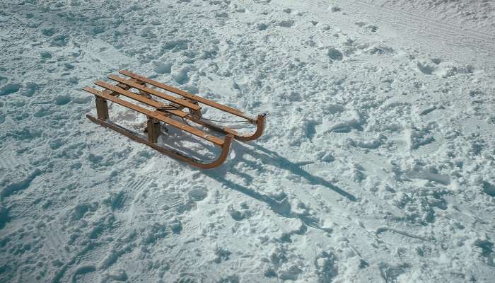 Experience the thrill of snow sledding down a snow-covered mountain.