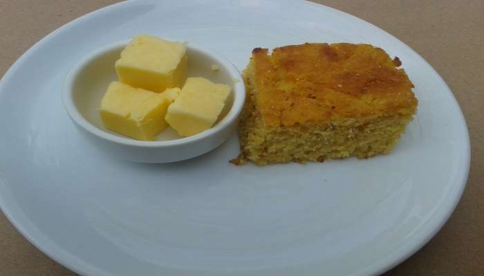 Mısır ekmeği with butter, served as an amuse-bouche at a restaurant.