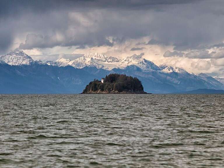 Sentinel Island Lighthouse with the Chilkat Mountain Range leading up to Haines and Skagway, Southeast Alaska.