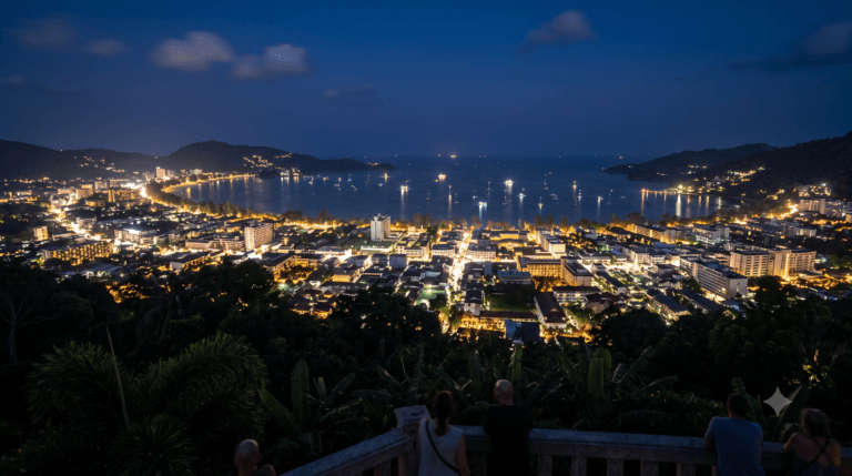 Patong beach city lights curving around the bay at night, Phuket, Thailand