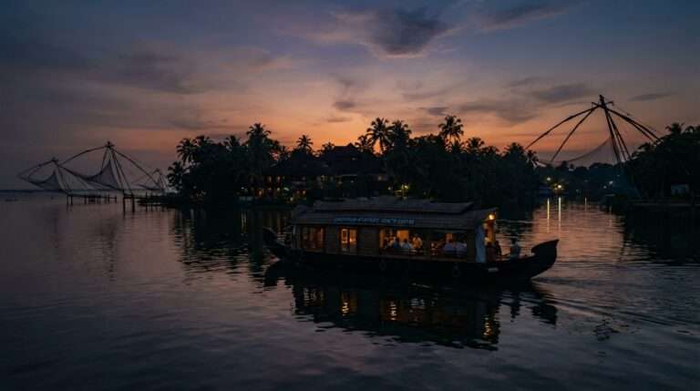 A backwater cruise boat on Ashtamudi Lake at dusk, Sarovaram Ayurvedic Health Centre, Kerala, India