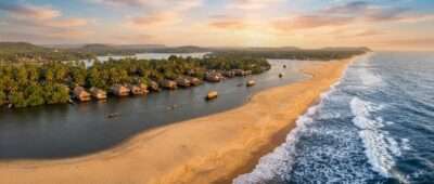 Aerial view of Poovar Island in Kerala where the backwater, river and Arabian Sea meet across a golden sand bar