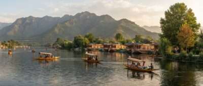Shikaras on Dal Lake in Srinagar, Kashmir, in September with houseboats and green Zabarwan