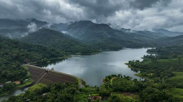 Pothundy Dam reservoir below the forested Nelliyampathy hills under monsoon clouds, Nelliyampathy, Kerala, India