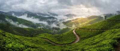 Monsoon clouds drifting over the green tea estates of Munnar, one of the best places to visit in Kerala during monsoon