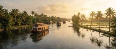 Kettuvallam houseboats on Vembanad Lake backwaters at golden hour, the largest of the lakes in Kerala, India