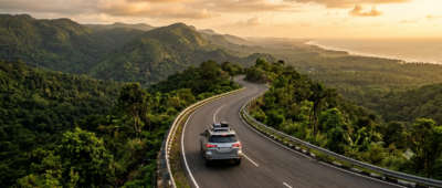SUV on a winding Western Ghats highway on a Mumbai to Kerala road trip, India